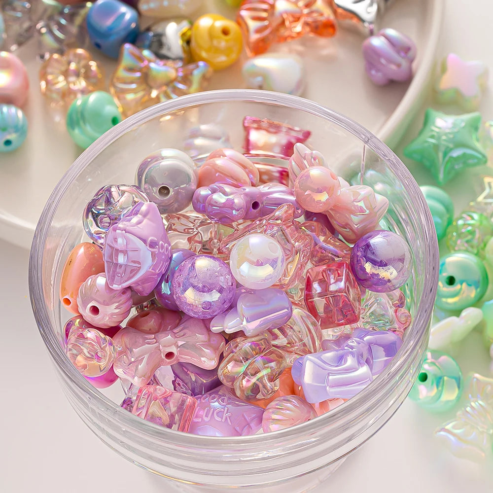A clear bowl filled with colorful Y2K acrylic bow and flower beads for DIY jewelry making