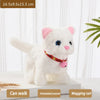 A white plush cat toy with pink accents and a red collar is shown on a white surface.
