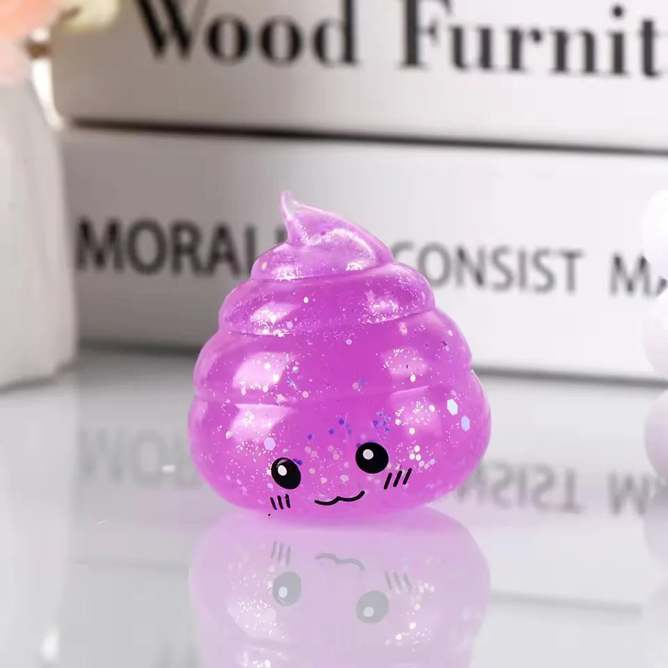 A small, translucent purple glitter squishy stress ball shaped like a smiling face resting on a reflective surface.