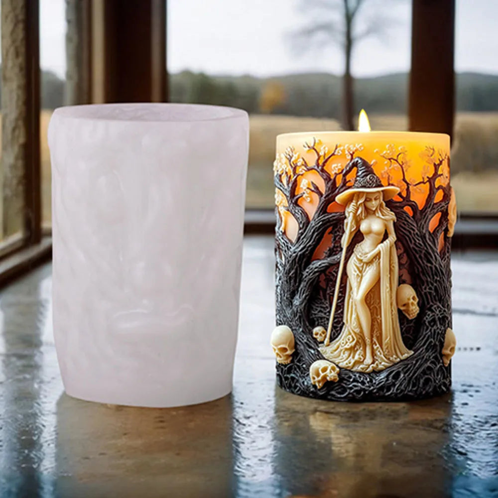 A lit candle in a glass holder featuring a Halloween witch portrait design.