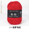 A ball of bright red milk cotton yarn labeled with Chinese characters and a size designation.