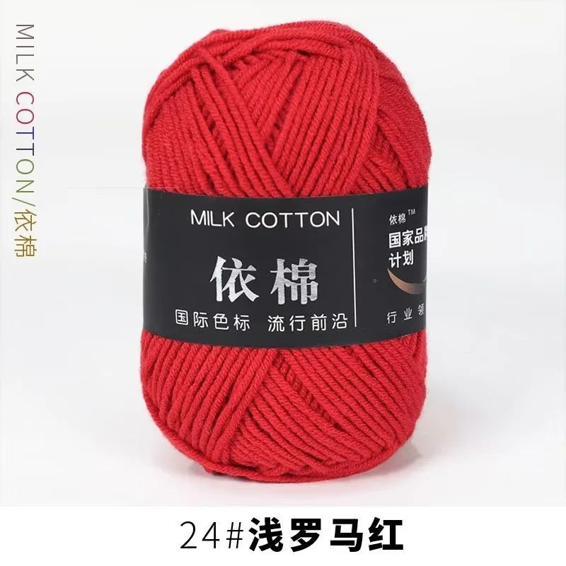 A ball of bright red milk cotton yarn labeled with Chinese characters and a size designation.