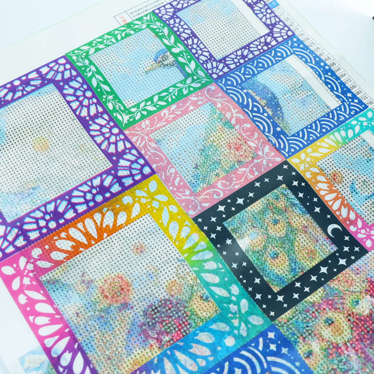 A colorful sheet of reusable non-stick release paper for diamond painting featuring various patterns and designs.
