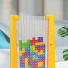 A yellow puzzle board with transparent strips holds colorful building blocks for a creative tangram toy.