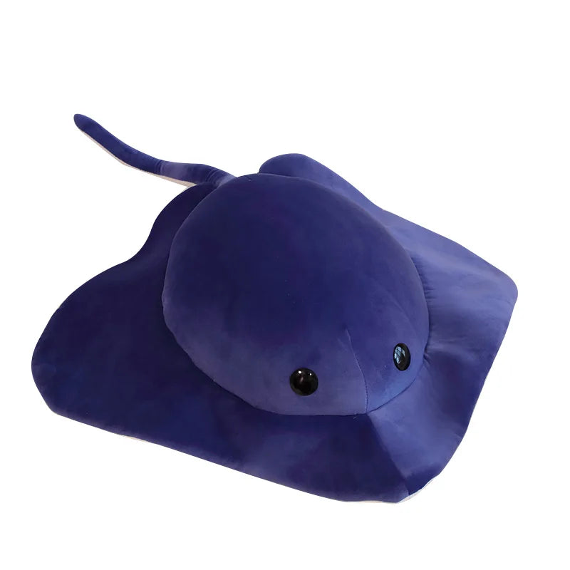 A dark blue plush toy of a cartoon ray devil fish with a soft, velvety texture.