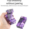 A hand holds a purple fidget cube with a starry sky design, demonstrating its smooth flip feature.