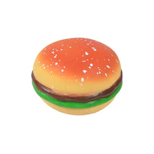 A squishy sensory toy shaped like a hamburger with an orange bun, green lettuce, and brown patty.