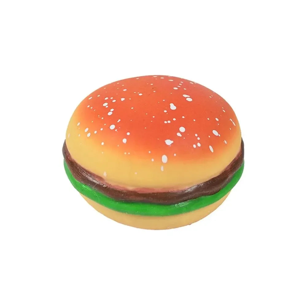 A squishy sensory toy shaped like a hamburger with an orange bun, green lettuce, and brown patty.