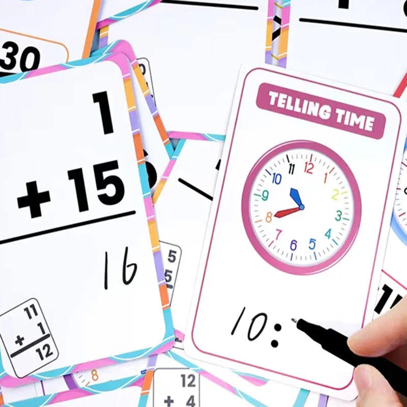 A close-up of colorful early learning flash cards showing numbers and shapes, with a hand holding a marker.