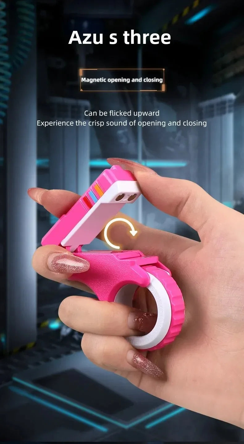 A hand holds a pink magnetic fidget card with a spinner, demonstrating its opening and closing mechanism.
