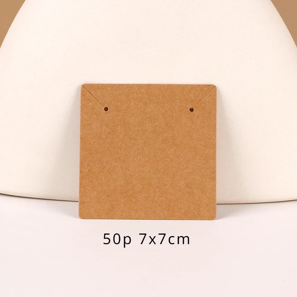 A square brown kraft card display with gold-colored hanging loops, shown against a light background.