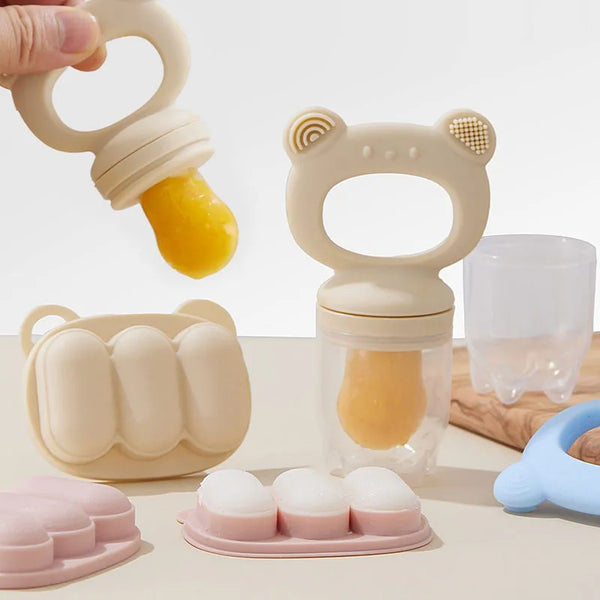 A silicone fruit teether set showing various shaped silicone fruits and a silicone teething ring on a light surface.