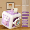 A white and purple children's busy ball cube with a simulated steering wheel and various sensory features.