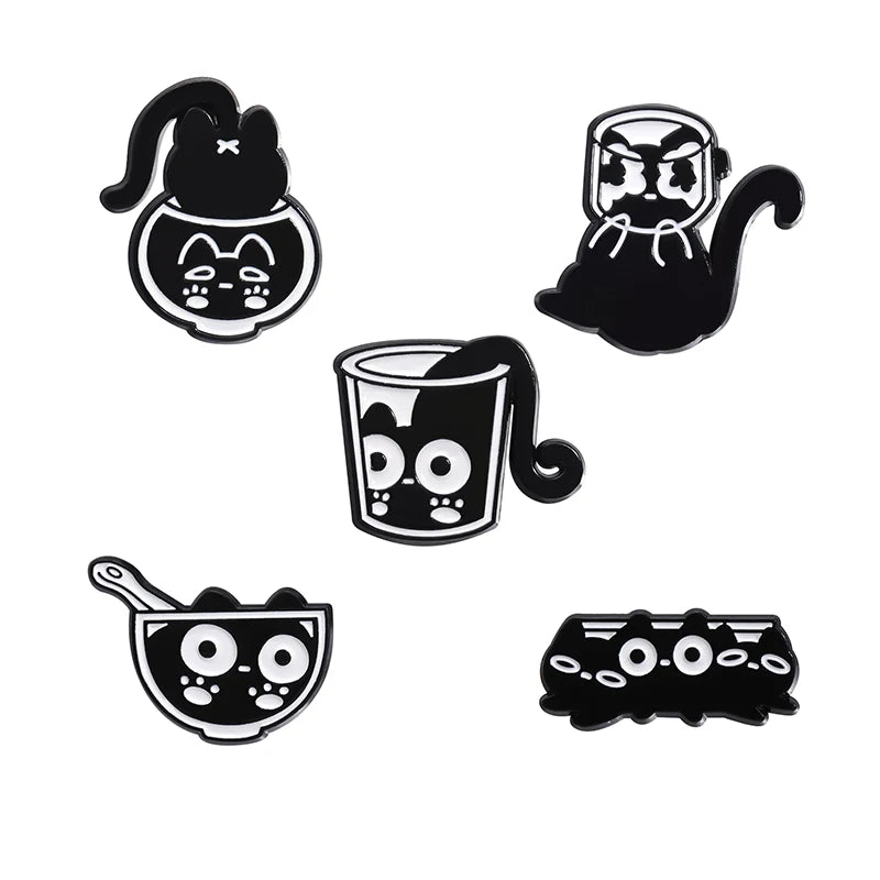 A set of four black cat enamel pins featuring various cat faces and designs.