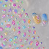 Collection of iridescent nail art stickers featuring gold shells and starfish on a clear sheet.