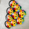 A cluster of handmade crochet sunflower decorative smile orbs in various bright colors on a white fluffy surface.