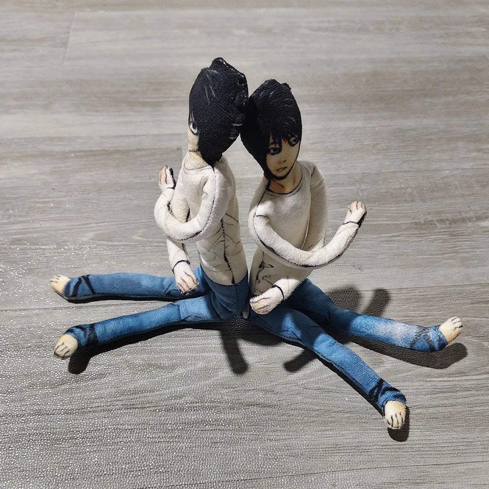 A pair of poseable plush dolls resembling L Lawliet from Death Note, dressed in light beige tops and blue jeans.