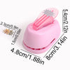Pink lever action embosser tool with a plastic handle and a metal die for scrapbooking