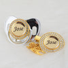 A gold and silver crystal pacifier and clip set featuring the name Jose
