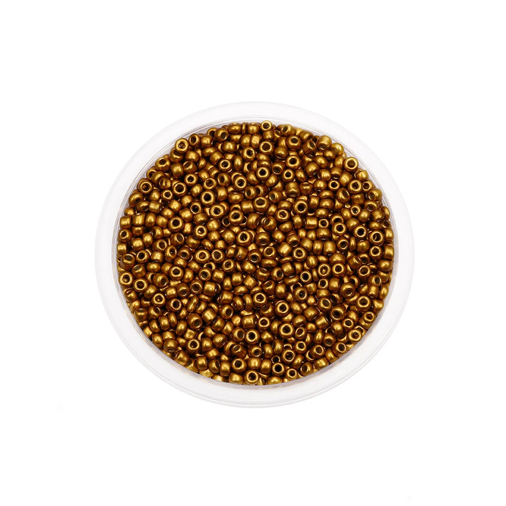 A clear container filled with small, round, gold-colored glass seed beads for jewelry making.