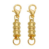 A pair of gold-colored magnetic clasps for jewelry making with jump rings.