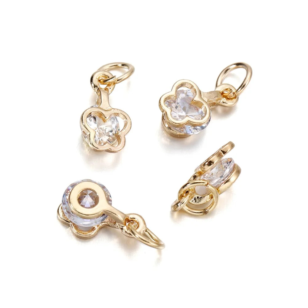 Gold and silver rhinestone heart charms for jewelry making displayed on a white background.