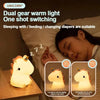 A close-up of a white unicorn silicone LED night light illuminating a sleeping person's face.