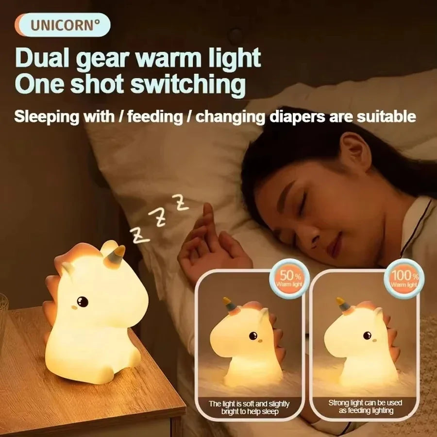 A close-up of a white unicorn silicone LED night light illuminating a sleeping person's face.