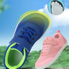 A blue children's sneaker is shown with a transparent sole, next to a pink mesh sneaker and a hand showing the wide toe box.