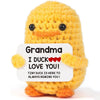Handmade crochet yellow duck doll with a smiling face and orange feet