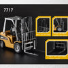 A yellow die-cast toy excavator construction vehicle with a metal guard and various movement features shown in close-up views