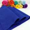 A stack of deep blue felt fabric sheets and various colored felt rolls are displayed on a white surface.