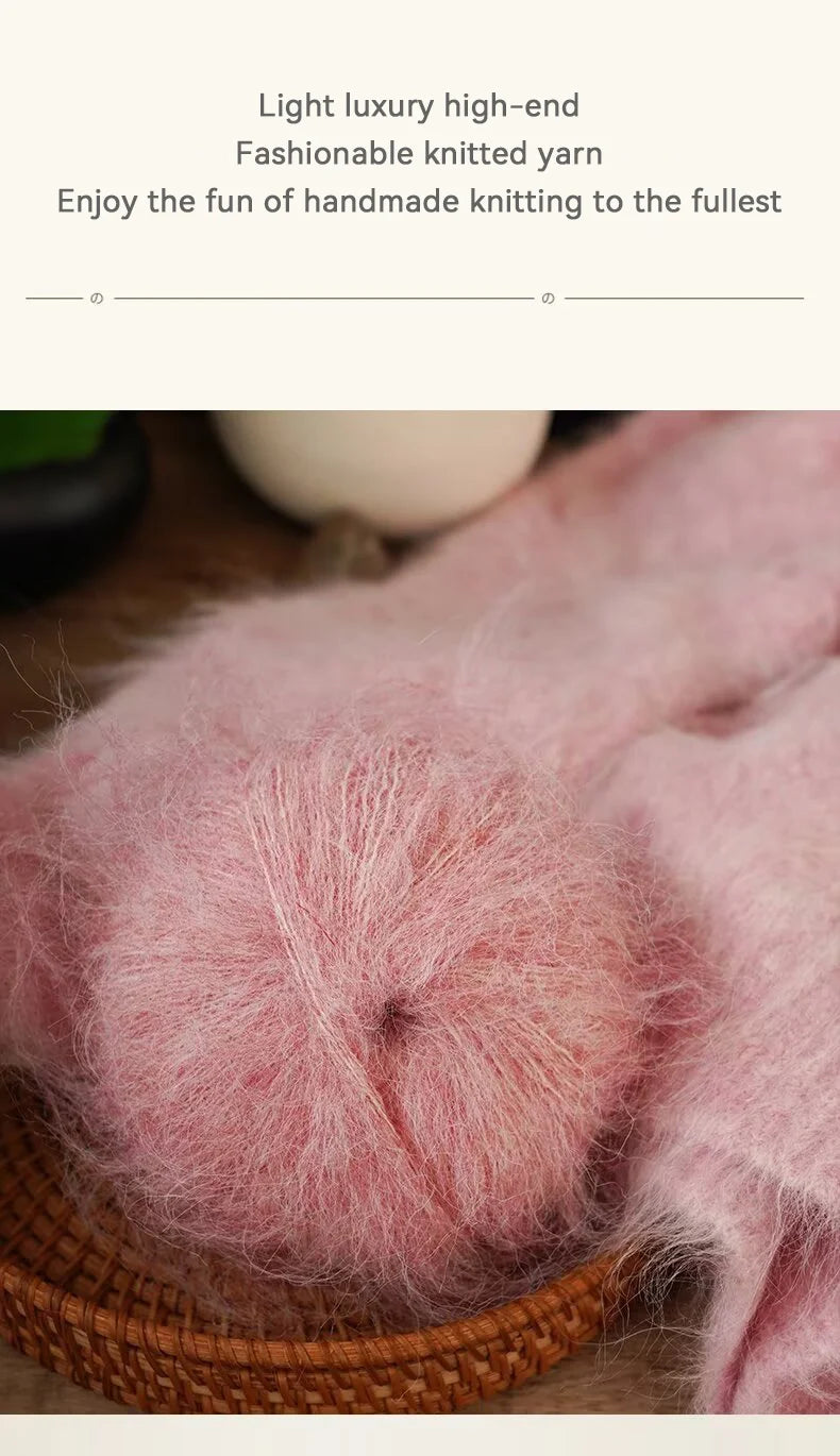 Close-up of fluffy pink knitted yarn being used for handmade knitting.