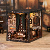 A dark wooden book nook kit featuring a detailed vintage music room scene with miniature furniture and LED lighting.