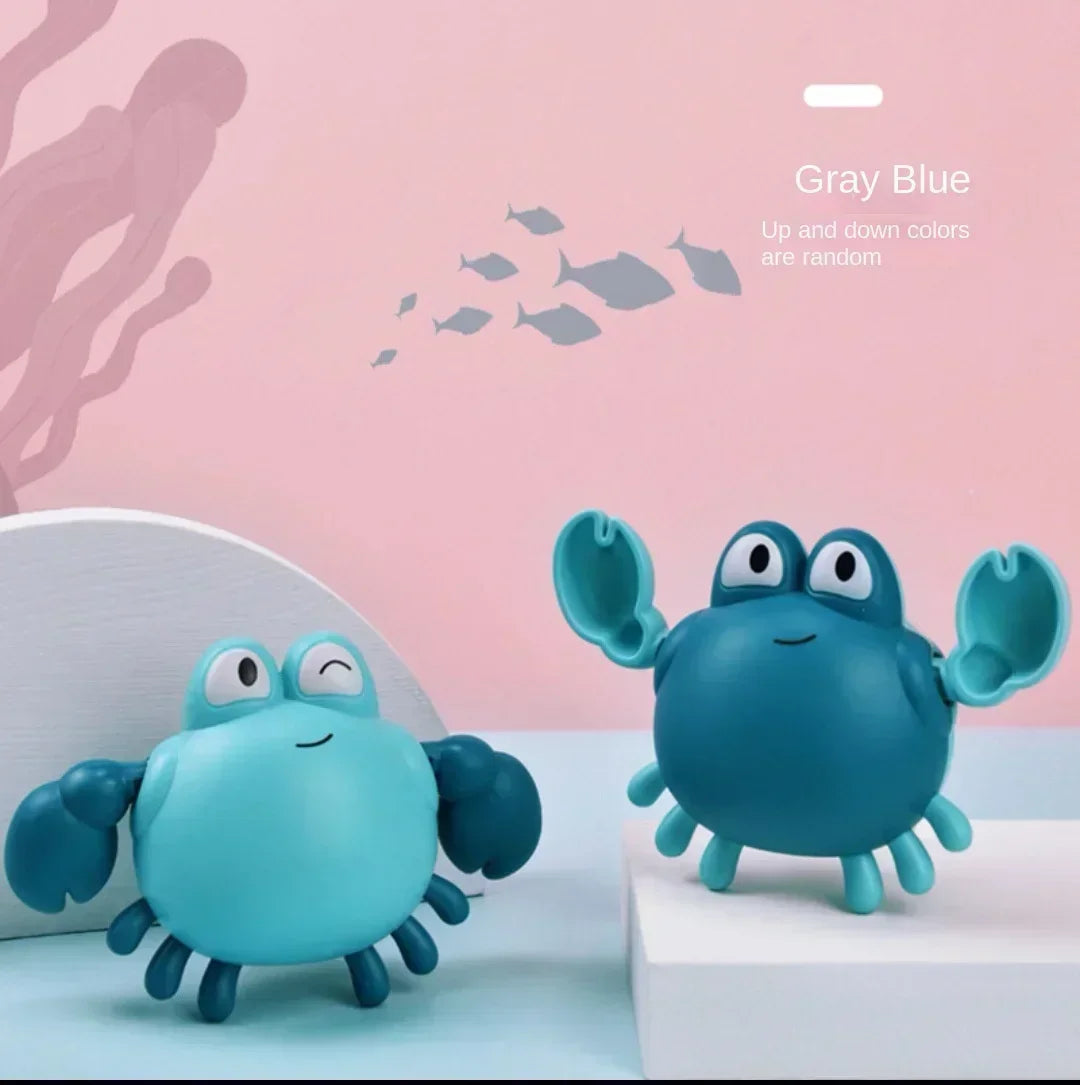A blue wind-up swimming duck bath toy sits on a white surface against a pink background.