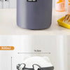 A white bear-shaped stackable bento lunch box with glasses is shown next to a gray fabric lunch bag.