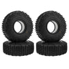 A pair of black Super Bouncer 1.9 crawler tires mounted on black rubber mounts.