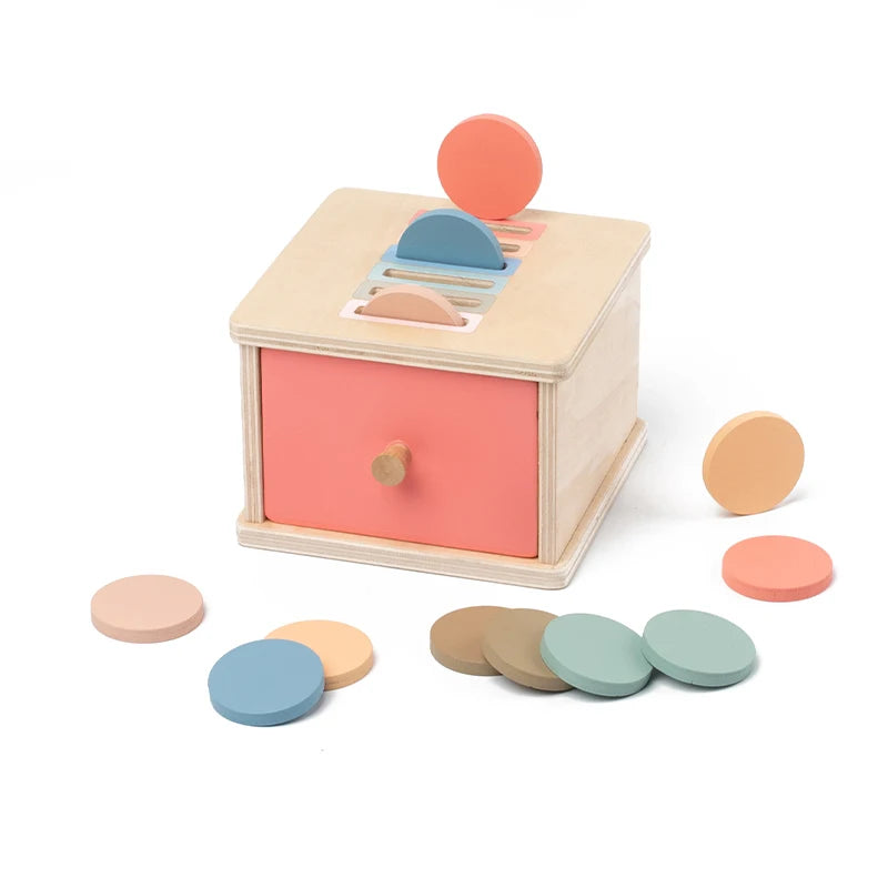 A wooden Montessori color sorting and shape sorter box with various colored discs and a lid.