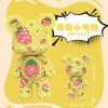 A yellow brick art bear figure made of small pink and green building blocks with a small flower bouquet.