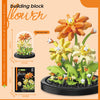 A kit for building a flower arrangement using building blocks, featuring orange and yellow floral components.