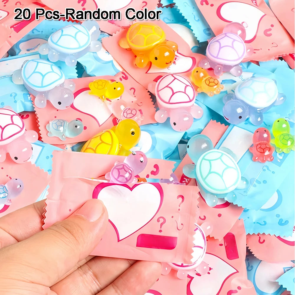 A hand holds a collection of 20 glow in the dark mini turtle collectible figurines in various colors and shapes.