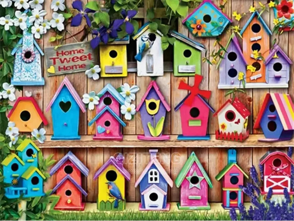 A collection of colorful wooden birdhouses and houses in various shades of blue, pink, yellow, and green arranged against a w