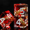 A set of red resin dice with golden elven numbers, including a 2 and a 5, resting on a dark surface.