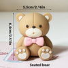A seated tan teddy bear with pink accents, measuring 5.5cm high.