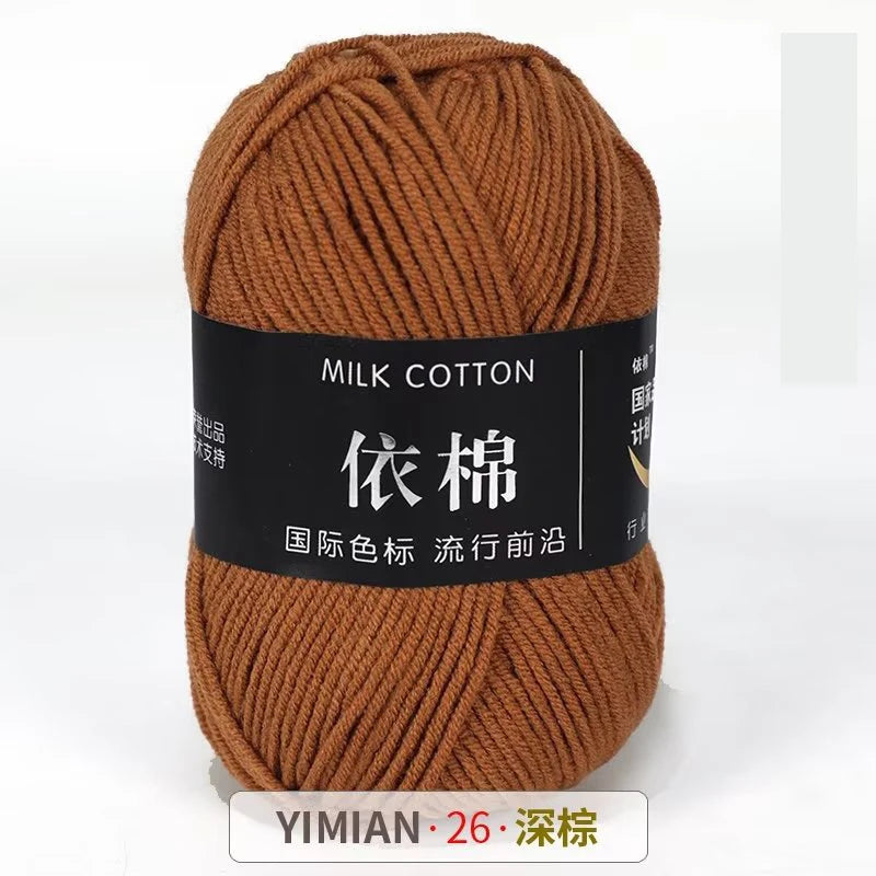 A ball of brown milk cotton yarn labeled with Chinese characters and a YIMIAN size tag.