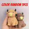 A hand holds a random 1pc Scottish Highland cow stress relief squishy toy.