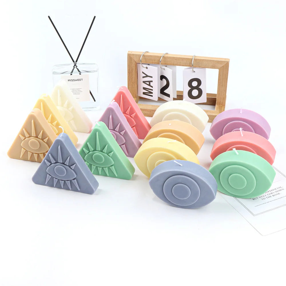 A collection of silicone molds shaped like evil eyes in various colors and sizes for candles, soap, and resin art.