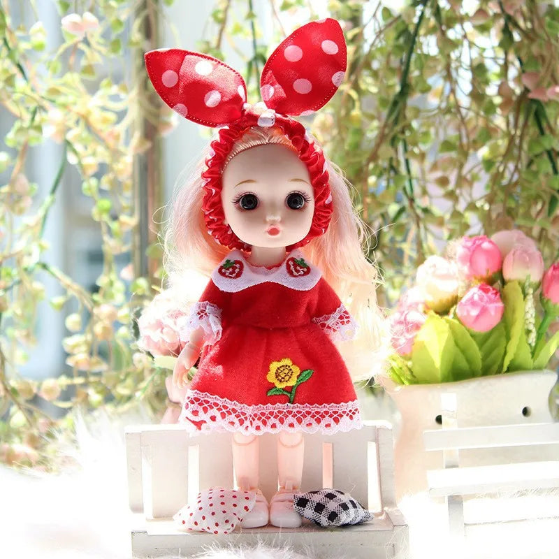 A 17cm articulated princess doll with a red dress and matching outfit, featuring large red ears and pink hair.