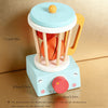 A wooden kitchen play set featuring realistic orange food items and a light blue and yellow design.