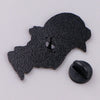 A black enamel pin shaped like a cartoon dog head.